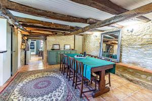 a kitchen with a table and chairs in a room at La Gaillardenque Gîtes - Farmhouse and Gîte in Floressas