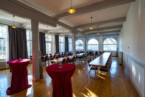 a large room with tables and chairs and windows at Gasthof - Auszeit im Bad Diezlings - Adults only in Hörbranz +37 photos
