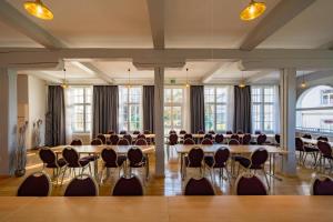 a large room with tables and chairs and windows at Gasthof - Auszeit im Bad Diezlings - Adults only in Hörbranz