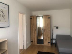 a room with a bed and a wooden door at Ferienwohnung Folke-Bernadotte in Lübeck