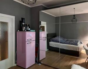 a room with a pink refrigerator and a bed at Bett 4 you Hamburg-Alster in Hamburg
