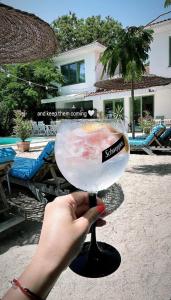a hand holding a martini glass with a sandwich in it at Casa De Mare in Olimp