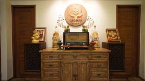 a tv on top of a wooden dresser in a room at Gordnuea Boutique House- SHA Extra Plus in Chiang Mai