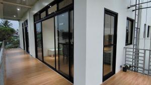a hallway of a building with large glass windows at Ormoc Mountain View Apartment in Ormoc