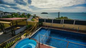 a swimming pool on top of a building next to the water at Horizon Lodge in Diamond Island