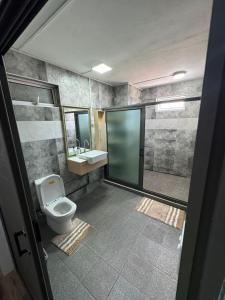 a bathroom with a toilet and a sink at Horizon Lodge in Diamond Island