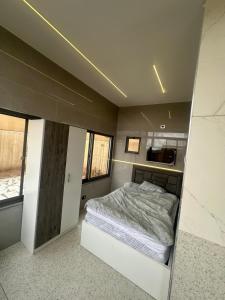 a bedroom with a bed in a small room at the royal occasion amman in Amman +11 photos