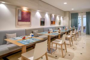a row of tables and chairs in a restaurant at NH Collection Marbella in Marbella +37 photos