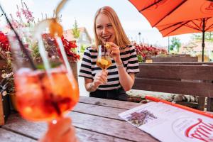 a woman sitting at a table eating a drink at Das Schierke Harzresort in Schierke +73 photos