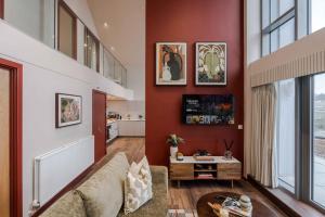 a living room with a couch and a table at Waterside Living I Luxe Apartments in Bristol