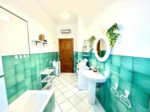 a bathroom with a sink and a toilet and a tub at Over the Rainbow in Sant'Agnello