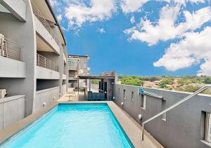 a swimming pool on the side of a building at Stylish Genisis on Fairmount U15 in Johannesburg
