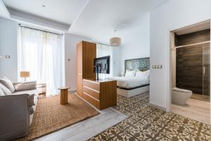 a hotel room with a bed and a television at Apartamentos "El Escondite de Triana" in Seville +87 photos