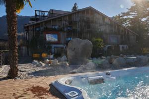 a house with a swimming pool in front of a house at Hosler in Merano