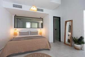 a bedroom with a large bed and a large mirror at Amore Luxury Villas Resort in Athani +66 photos