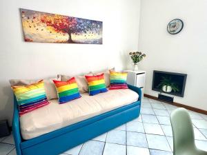 a couch with colorful pillows in a living room at Over the Rainbow in Sant'Agnello