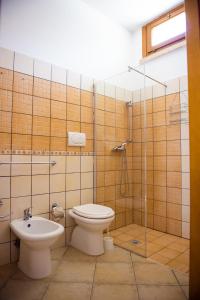 a bathroom with a toilet and a shower and a sink at Villa Conca Marco in Torre dell'Orso +68 photos