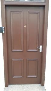 a brown door with two panels on it at 4B Wentworth Street Apartment in Portree