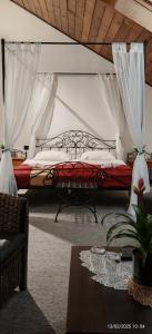 a bedroom with a bed with curtains and a table at Hotel Plzeňský Dvůr in Frýdek-Místek