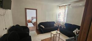 a living room with a couch and a chair at Borbardha the 7 xhuxhat in Tropojë