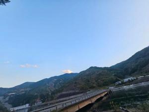 a train traveling over a bridge over a mountain at Borbardha the 7 xhuxhat in Tropojë