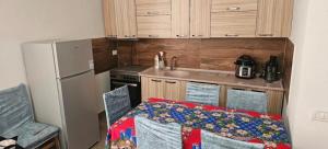 a small kitchen with a table and a refrigerator at Borbardha the 7 xhuxhat in Tropojë