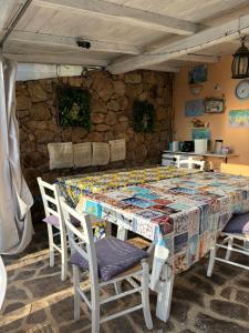 a table in a kitchen with a table and chairs at Casa Azzurra in Porto San Paolo +28 photos