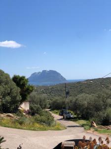 a winding road with a mountain in the distance at Casa Azzurra in Porto San Paolo