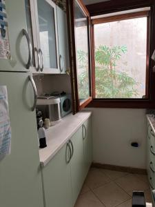a kitchen with a sink and a window at Casa Azzurra in Porto San Paolo