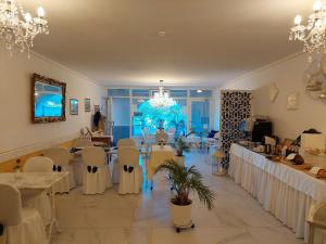 a room with tables and chairs and a chandelier at Dolceresio Lugano Lake B&B in Brusino Arsizio