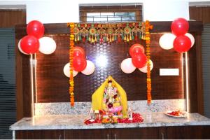 a room with a altar with red and white balloons at Hotel Subhadra in Kannauj