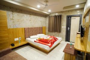 a bedroom with a bed and a television in it at Hotel New Sundaram 150 Mtrs from Dargah in Ajmer