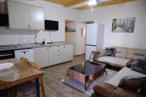a kitchen and living room with a couch and a table at Hacımemiş Alaçatı Home in Çeşme