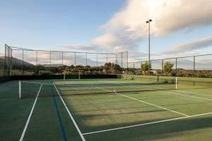 a tennis court with two tennis courts at Casas Novas Countryside Hotel Spa & Events in Chaves +90 photos