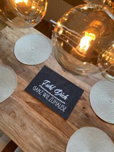 a wooden table with a candle and glasses on it at Chalet Wienerwald in Königstetten +28 photos