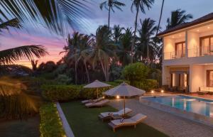 a villa with a swimming pool and a resort at Villa Blu in Tangalle