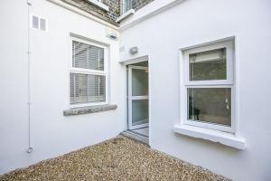 a white house with two windows on the side of it at Pearse Street Gardens in Dublin