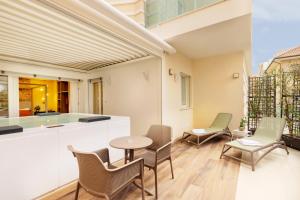 a balcony with chairs and a table and a counter at BeSUITE Apartments in San Benedetto del Tronto
