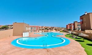 a large swimming pool on top of a building at Casa Kusama in Corralejo