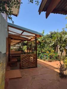 a wooden pergola with a bench under it at Ojac Guesthouse in Iten