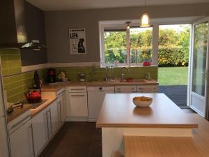 a kitchen with a counter with a bowl of fruit on it at Le Nid de Cissé in Cissé