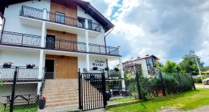 a building with a gate in front of it at Chyba Wyspa, Ostrowo in Ostrowo