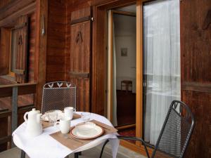 a table with a white table cloth and a chair at Apartment Chalet Abendrot apARTments-10 by Interhome in Grindelwald