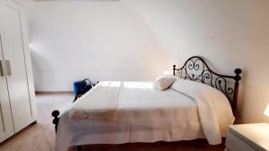 a bedroom with a bed with a white blanket at Casamilla in Procida