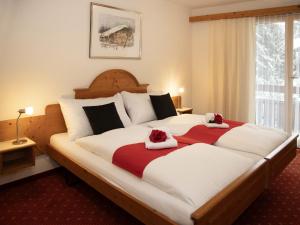 a bedroom with a large bed with two towels at Apartment Chalet Abendrot apARTments-25 by Interhome in Grindelwald