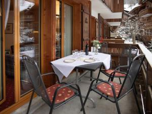 a dining room with a white table and chairs at Apartment Chalet Abendrot apARTments-25 by Interhome in Grindelwald