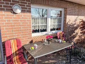 a table and chairs sitting on a patio at Apartment im Dörp-2 by Interhome in Waase