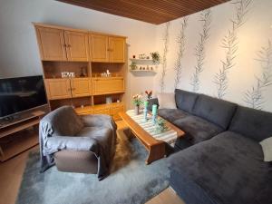 a living room with a couch and a coffee table at Ferienwohnung Waldmann 65356 in Moormerland