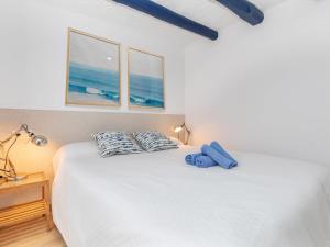 a bedroom with a bed with two pillows on it at Apartment Mestral Atic by Interhome in Tossa de Mar