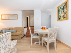 a living room with a table and chairs and a couch at Apartment Gregal by Interhome in Tossa de Mar